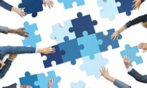 Employees in an organization build a puzzle together